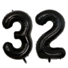 A set of two giant black foil balloons shaped like the numbers 3 and 2.