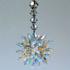 A sparkling crystal star ornament featuring a multifaceted, radiating design suspended from a delicate chain.
