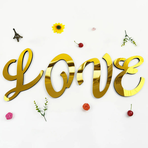 Gold 3D acrylic letter wall stickers spelling LOVE with scattered yellow flowers and red berries