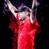 A portrait of Tiger Woods in a red shirt, raising his fist against a dark background with red smoke effects.