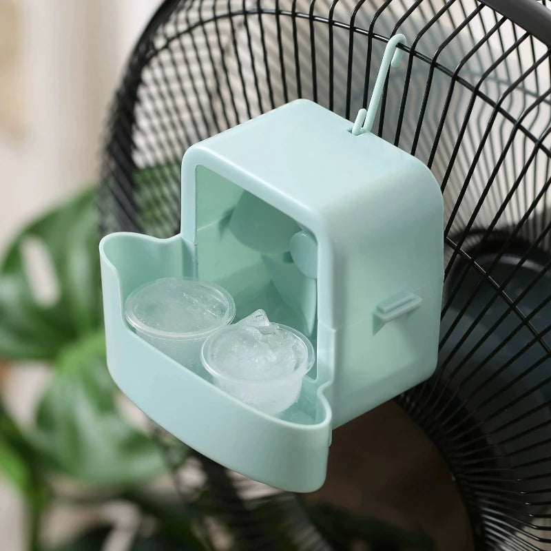 A light mint green portable ice-cooling floor fan with a clear ice holder is shown against a black fan grille.