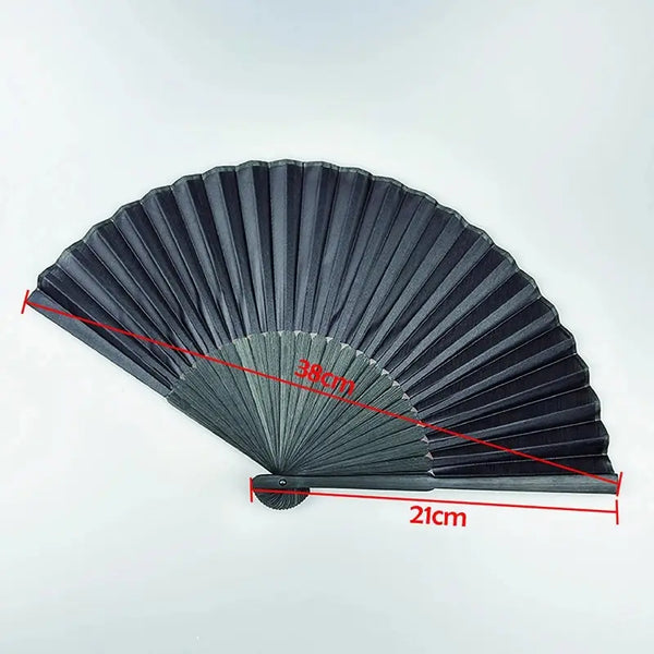 A black folding hand fan with a bamboo frame shown in a fan shape with measurements marked.