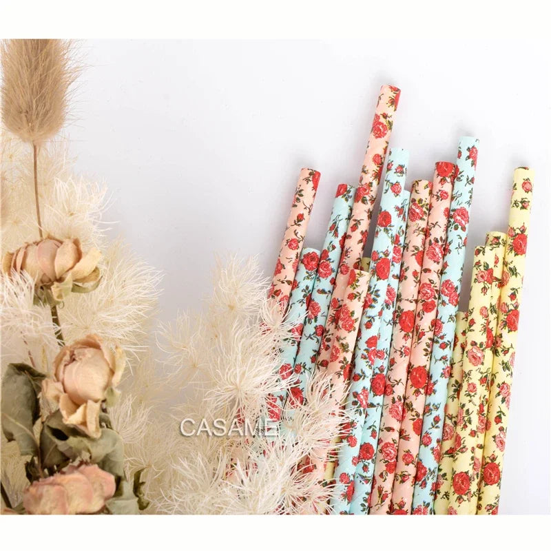 A bundle of colorful striped and polka dot paper drinking straws in various floral patterns.