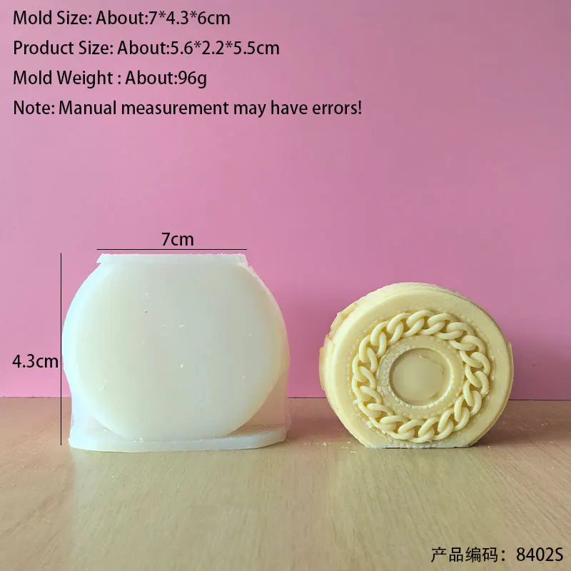 A white silicone mold for making candles or crafts is shown next to a finished, round candle product.