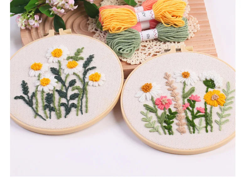 Punch needle embroidery kit featuring floral designs on stamped cloth with yarn tools