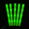 A bundle of bright green RGB glow foam sticks standing upright against a black background.