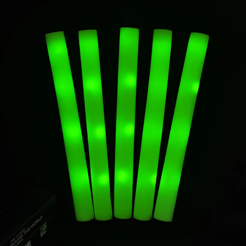A bundle of bright green RGB glow foam sticks standing upright against a black background.