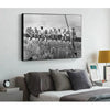 Black and white canvas wall art depicting a group of people standing on a ledge overlooking a New York City skyline.