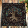 Dark velvet tarot cloth featuring a detailed tree root design in gold and teal accents.