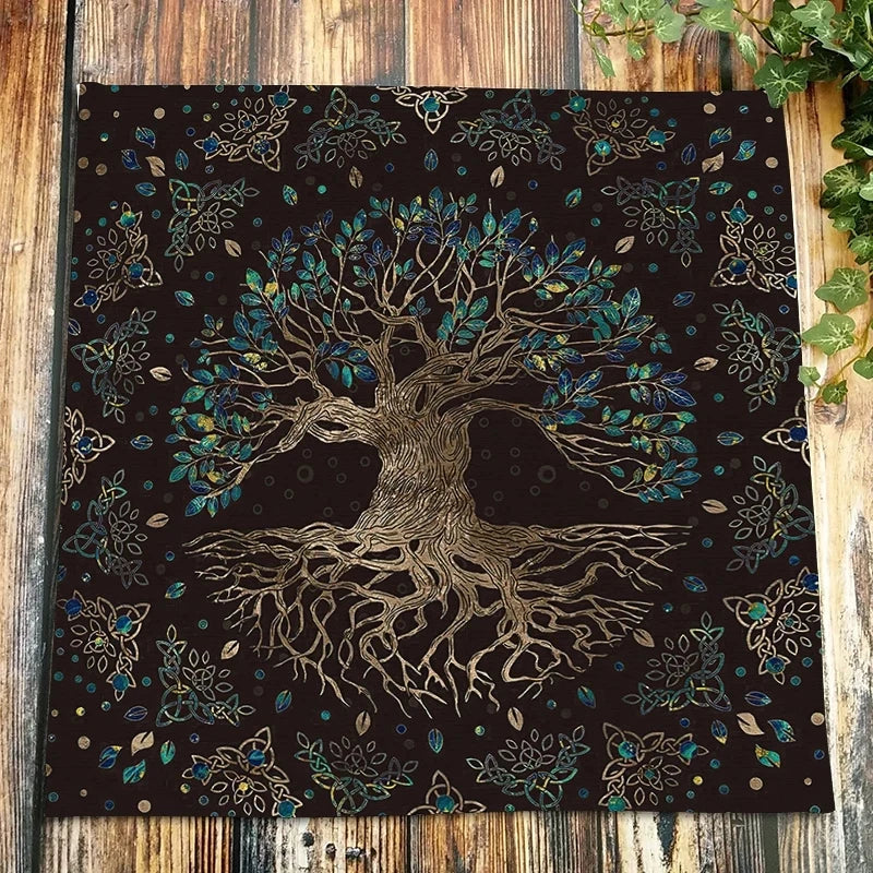 Dark velvet tarot cloth featuring a detailed tree root design in gold and teal accents.