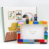 A DIY building block photo frame kit featuring figures and decorative elements on a white background.