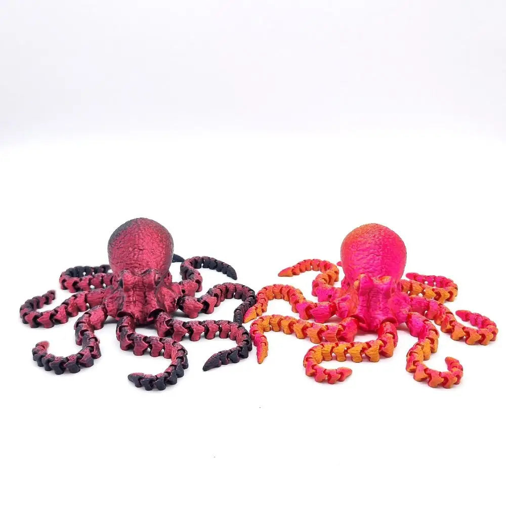 A pair of articulated 3D printed octopus figurines, one pink and one orange, displayed against a white background.