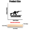 A black metal rifle statue with a custom name engraved on it, mounted on a wooden base.