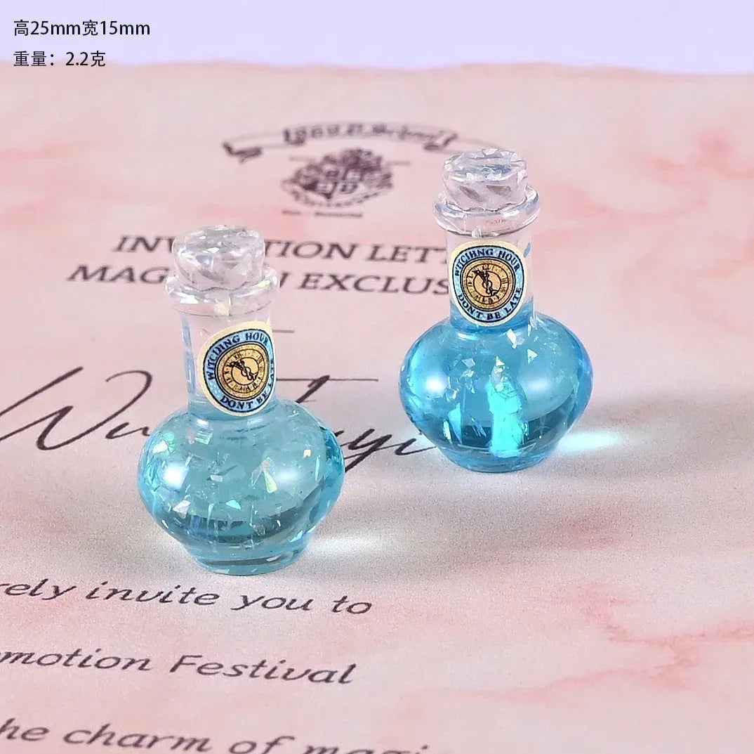 Two small glass bottles filled with blue liquid resin for dollhouse decor