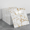 Stack of white marble peel-and-stick tiles featuring brown veining on a gray background.