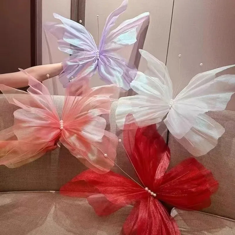 A display of silk artificial butterfly decorations in shades of purple, white, and red.