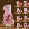 Pink glitter number candles 1 through 8 with bow decorations for birthday cake decoration