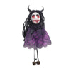 A dark witch ornament featuring black hair, purple fabric, and a gruesome face with red paint.