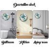 Decorative wall clock featuring a wooden turtle design in blue and teal on a light gray wall.