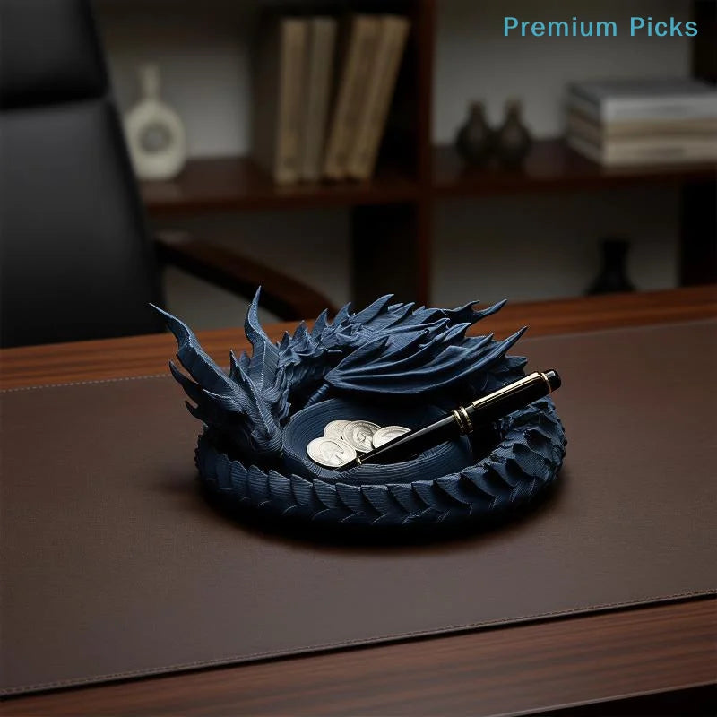 A dark blue dragon design decorative tray for jewelry and small items resting on a wooden surface.