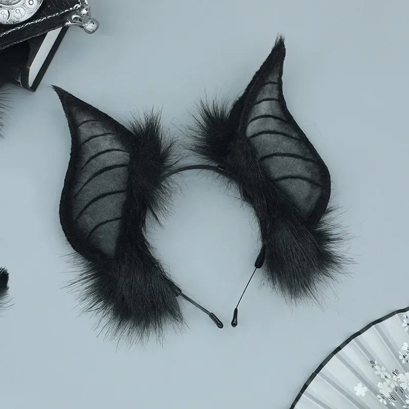 A pair of black bat simulation ears made of faux fur, displayed against a light background.