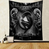 A dark tapestry wall hanging depicting a stylized alien predator with sharp teeth and menacing features.