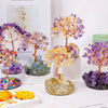 A collection of natural crystal trees featuring purple, yellow, and orange crystals used for home decor.