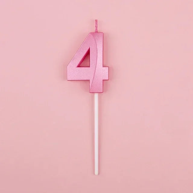 Pink number four candle on a white stick against a light pink background