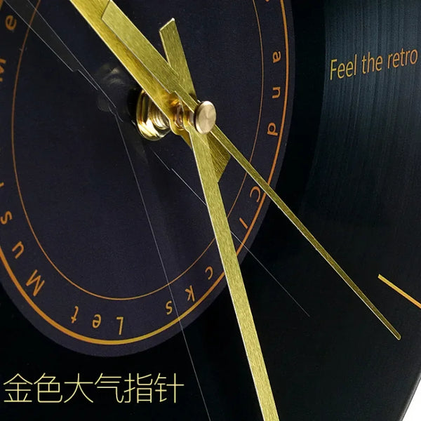 A close-up of a gold-colored hand on a black clock face, showing the time and markings.