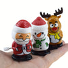 Three clockwork wind-up figurines of Santa Claus, a snowman, and a reindeer head for festive decor