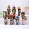 A collection of natural crystal wishing bottles filled with various raw stones and topped with gold accents.