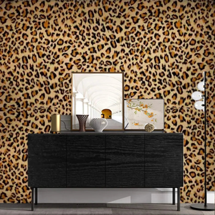 A dark dresser is displayed against a leopard print wall with a large mirror and decorative objects.