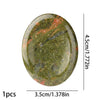 A smooth, oval natural stone bead with green and reddish-pink mottled patterns.