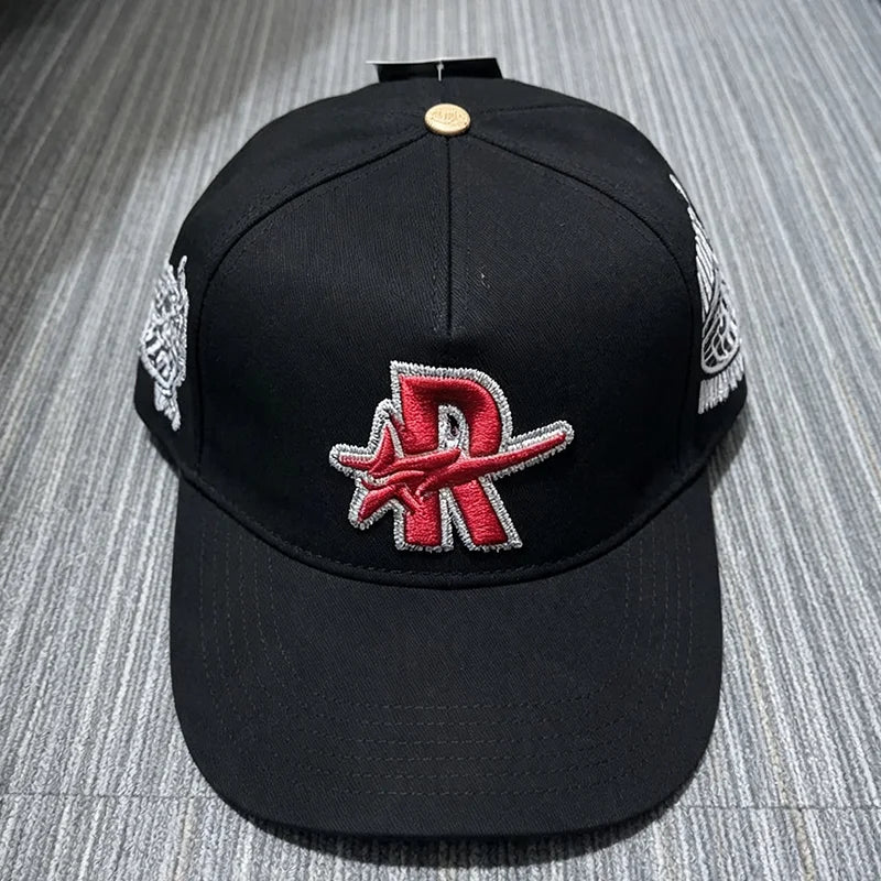 Black baseball cap embroidered with a red star logo and silver detailing