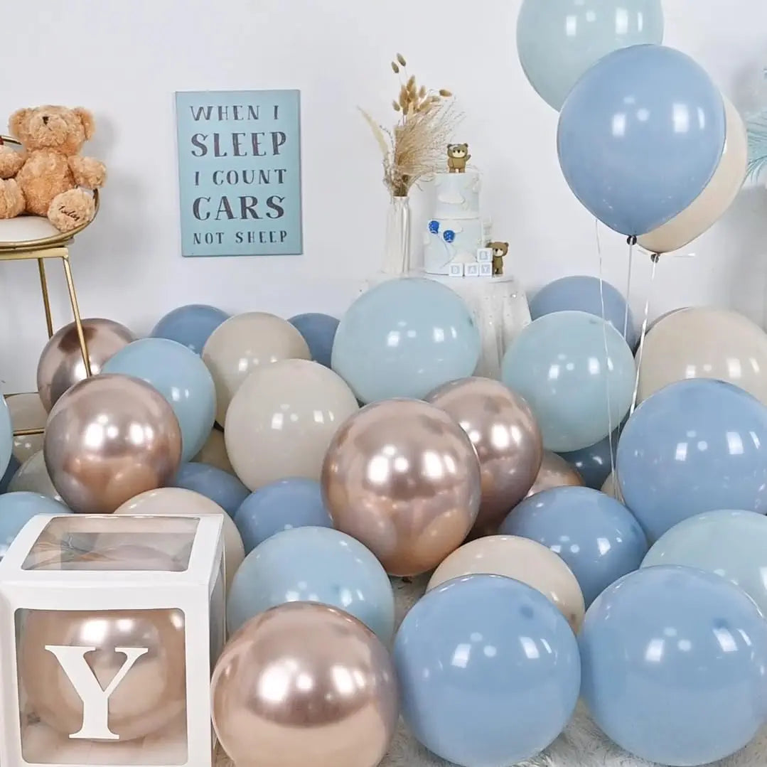 A collection of blue and beige balloons arranged in a garland arch display.