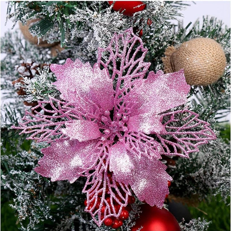 Pink silk artificial Christmas flowers with gold sparkle finish decorated on a green fir branch