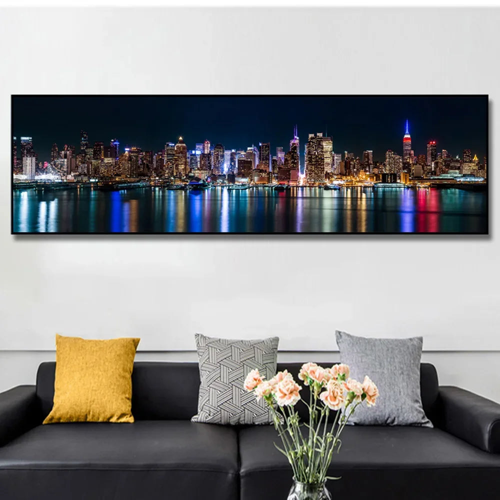A canvas print depicting the New York City skyline at night with city lights reflecting on water.