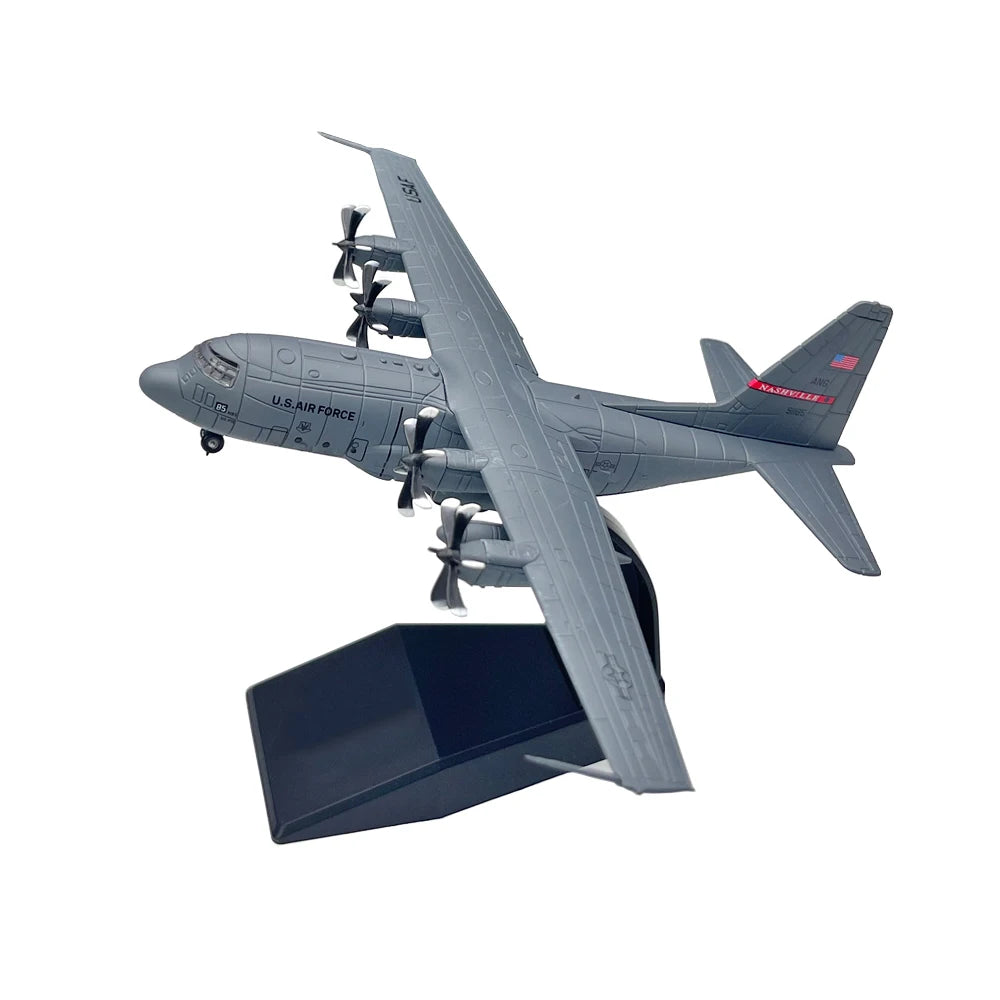 A gray diecast model of a U.S. Air Force C-130 Hercules aircraft in flight.