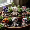 A collection of Halloween resin skeleton mummy figurine set featuring purple witch, zombie, and various mummified figures in 