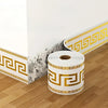 Roll of self-adhesive PVC baseboard trim featuring a gold Greek key pattern and a gray brick texture.