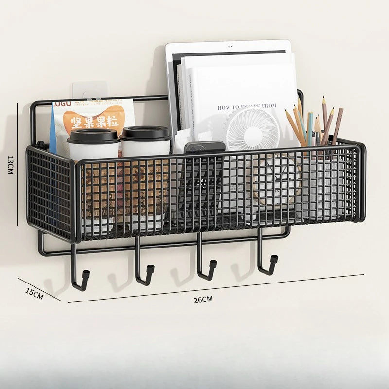 Black wire storage basket with compartments for books and pencils mounted on a wall.
