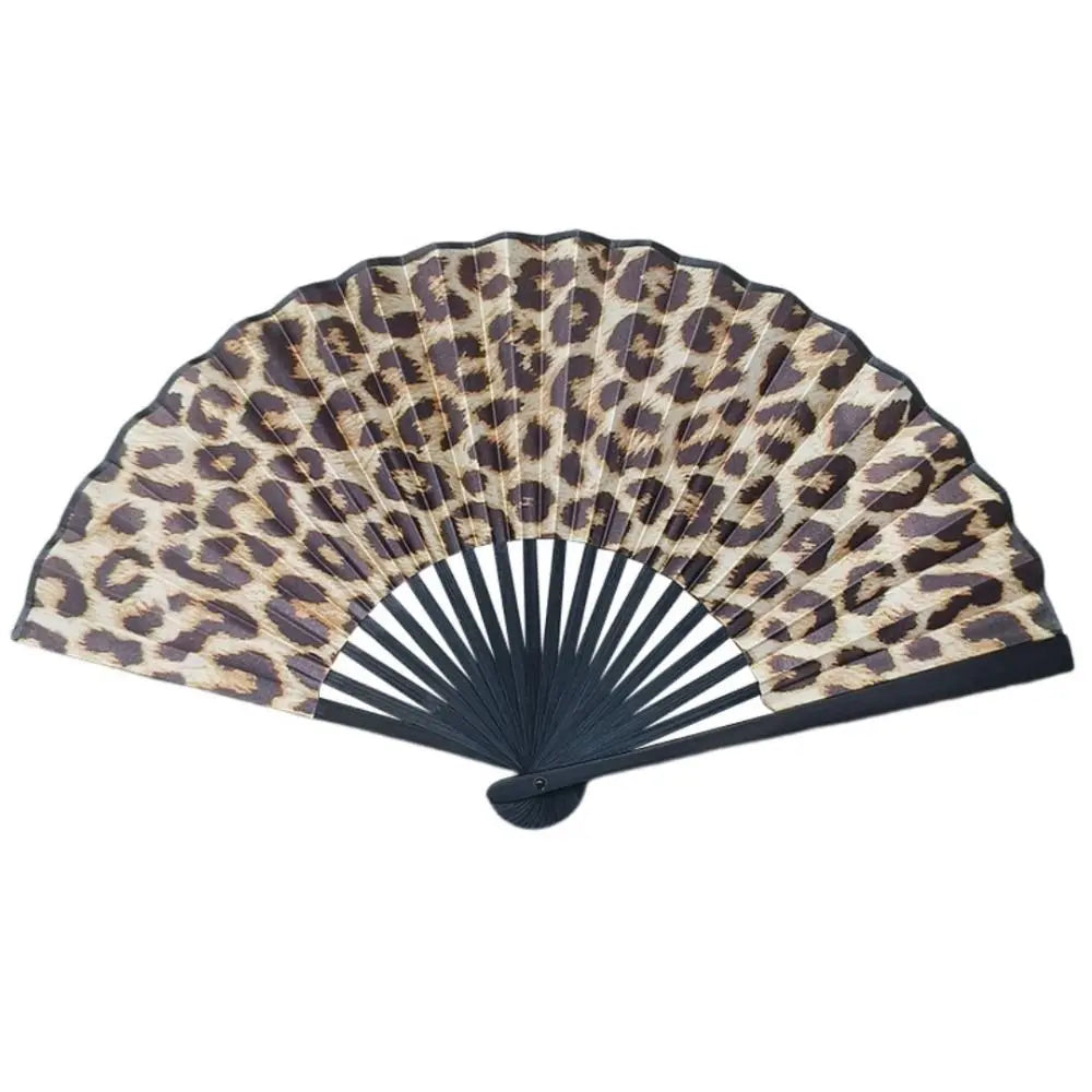 A folding hand fan with a leopard print design in shades of brown and black.