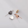 Three heart-shaped stainless steel bead charms in silver, gold, and rose gold tones