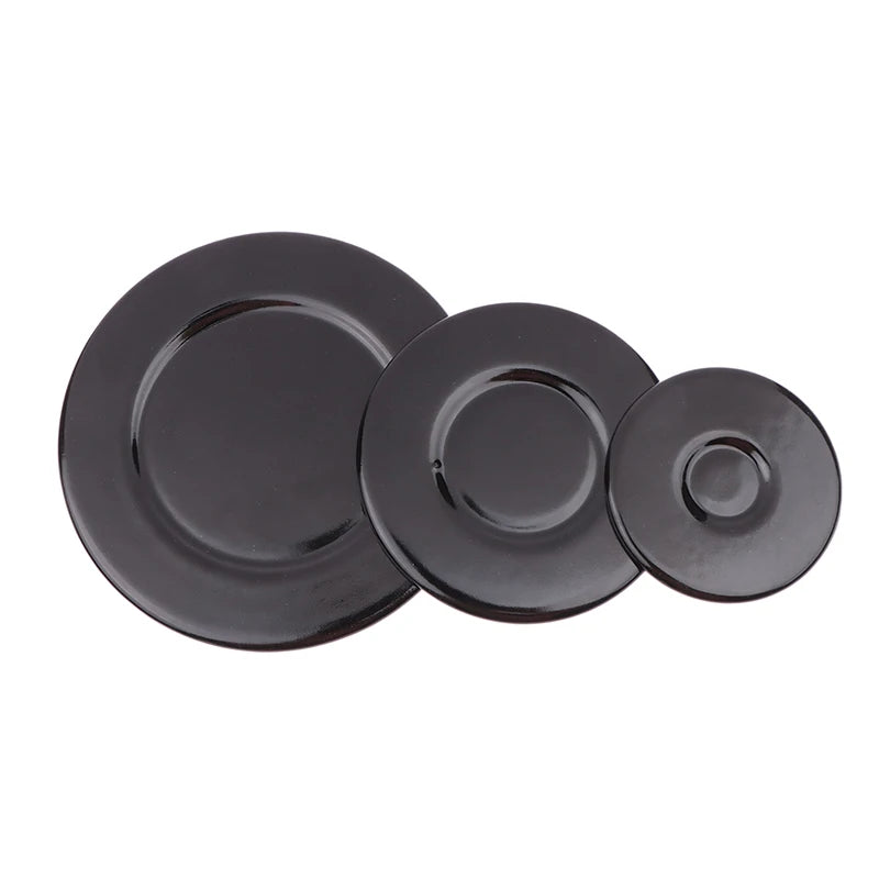 A set of black gas stove burner caps for efficient cooking.