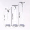 A set of three silver metal taper candle holders shown with various height options and bases.