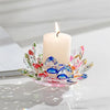 A clear crystal lotus candle holder with colorful glass petals and a white pillar tealight candle.