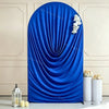 A vibrant royal blue stretchy spandex arch cover draped in soft folds, displayed against a light wall.