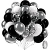 A bunch of black and silver balloons, including latex and foil types, tied together with strings.
