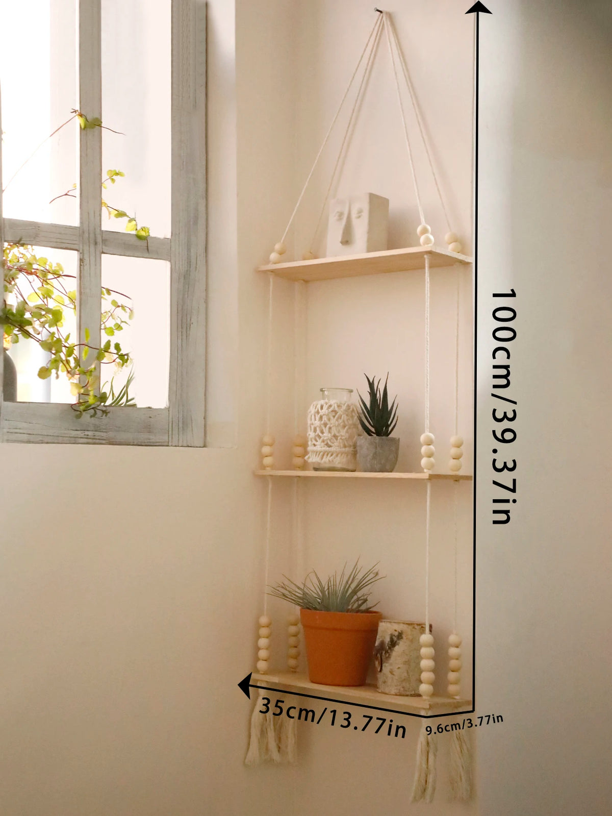 A vertical rustic wooden wall shelf with three floating shelves displaying potted plants and decorative items.