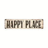 A weathered wooden sign with the text HAPPY PLACE carved into it.